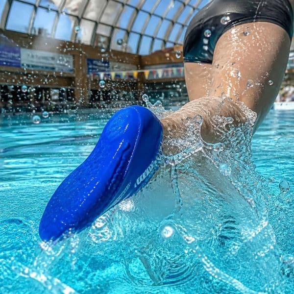 Swimmer wearing a blue verruca sock in a swimming pool to help contain verrucas and warts.